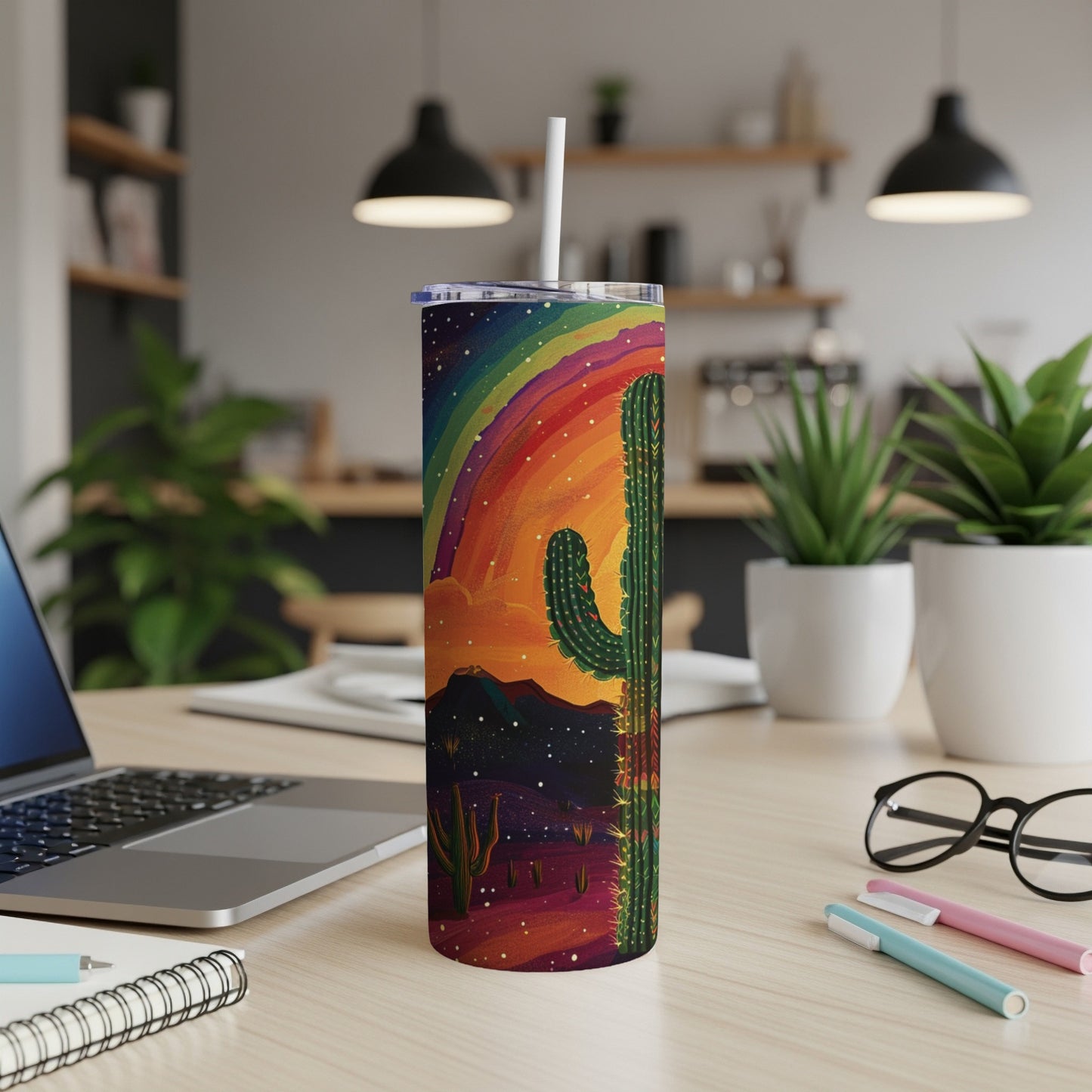 Desert landscape with rainbow and cactus on a tumbler with straw.
