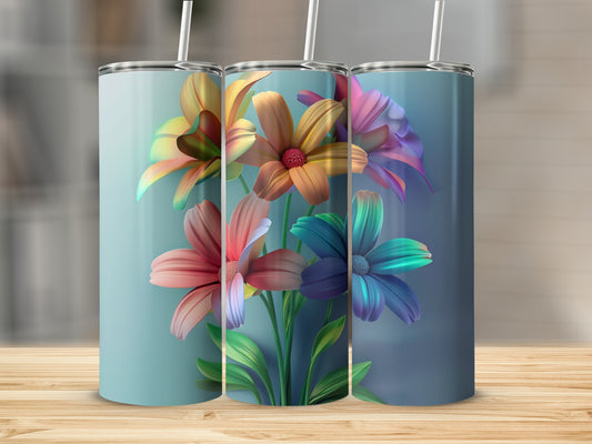 Three tumblers with colorful floral designs on a wooden surface.