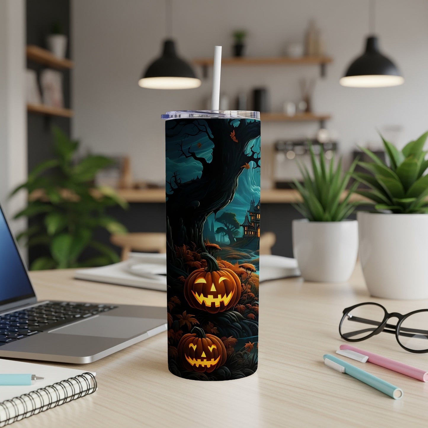 Tumbler with Halloween design featuring carved pumpkins, spooky tree, and haunted house.