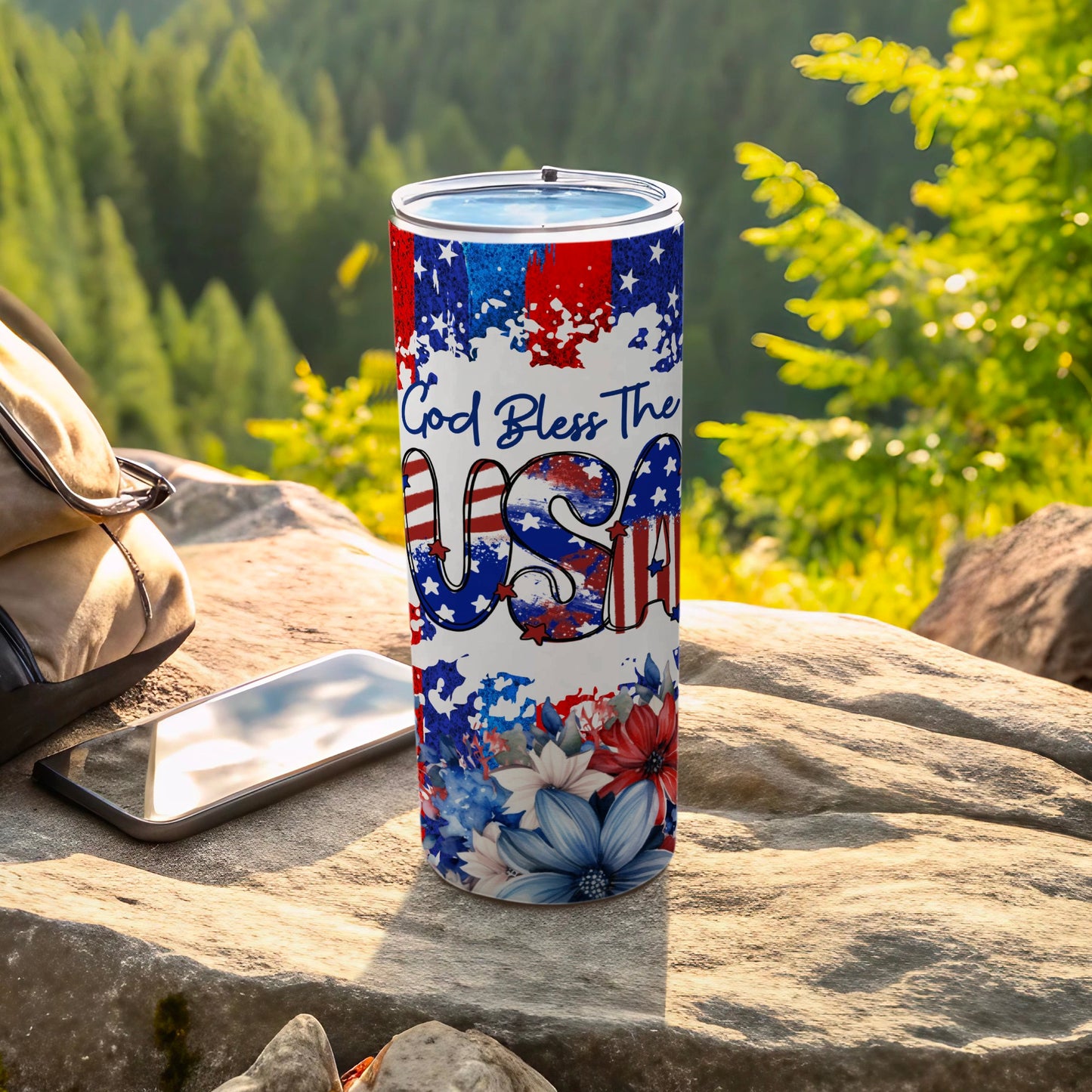 USA flag-themed tumbler with "God Bless The USA" text and floral accents.