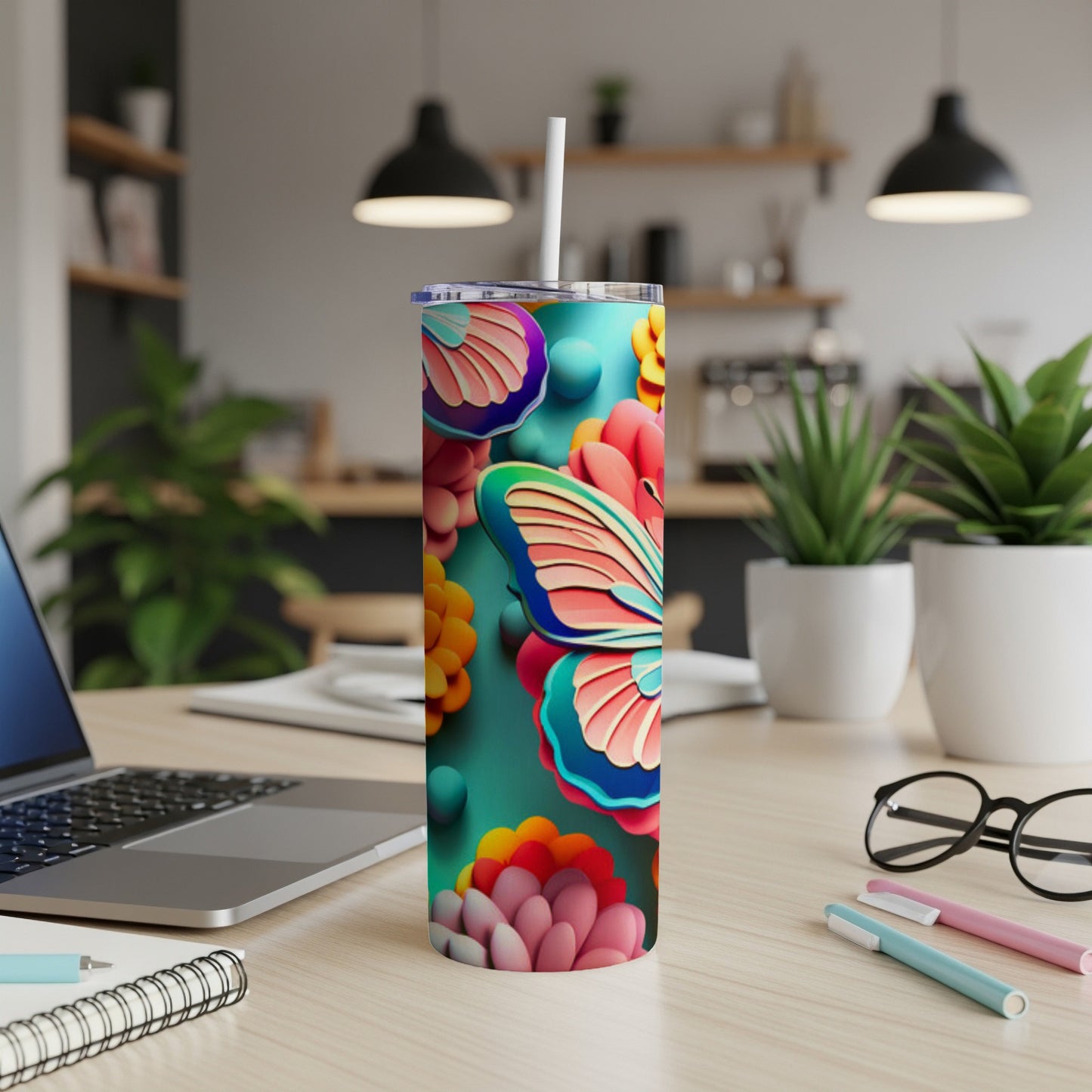 Tumbler with colorful butterfly and floral design on teal background.