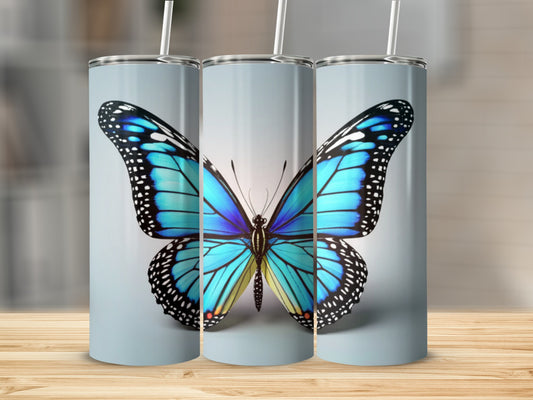 Blue butterfly on a cylindrical tumbler with a light gray background.