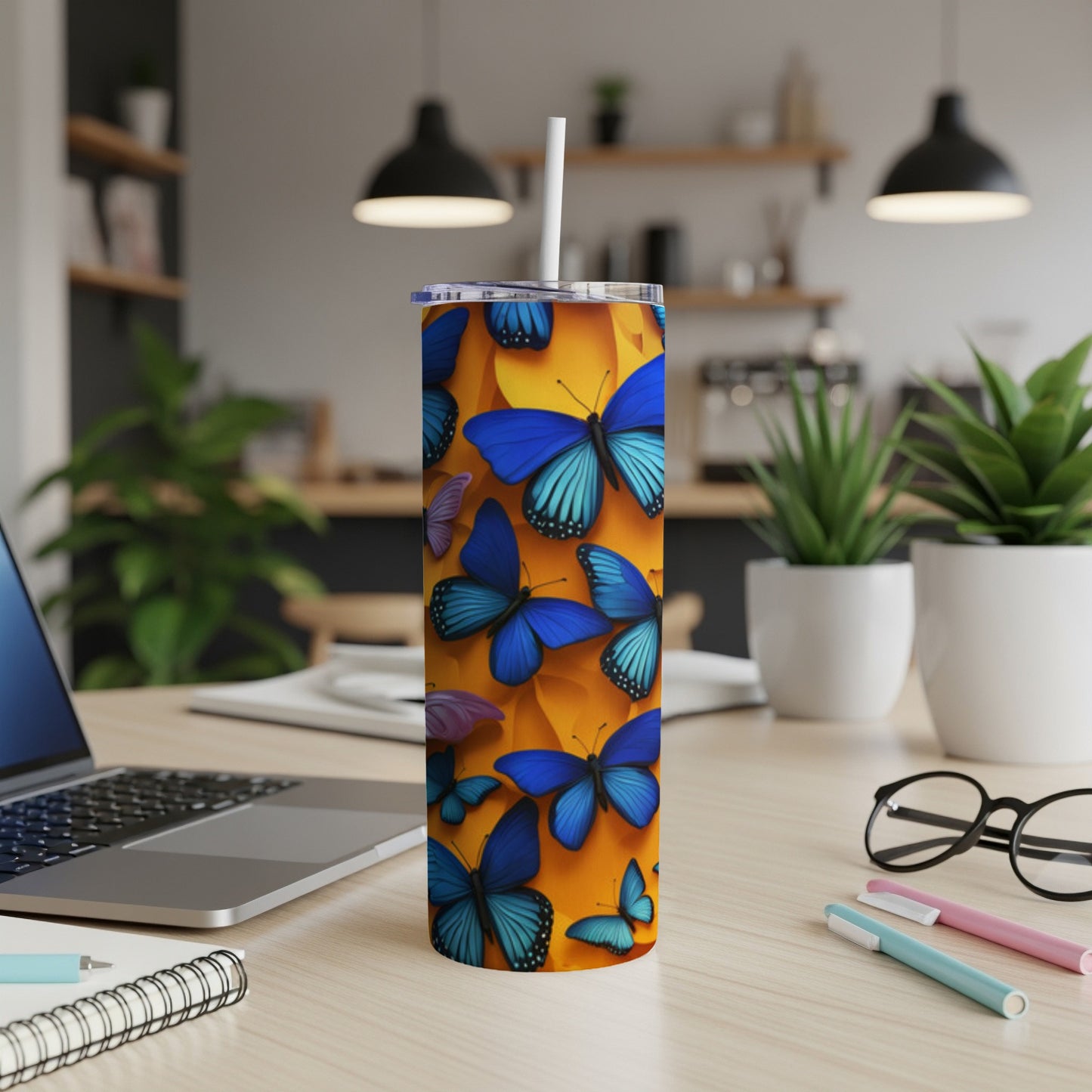 Tall tumbler with blue butterflies on an orange background.