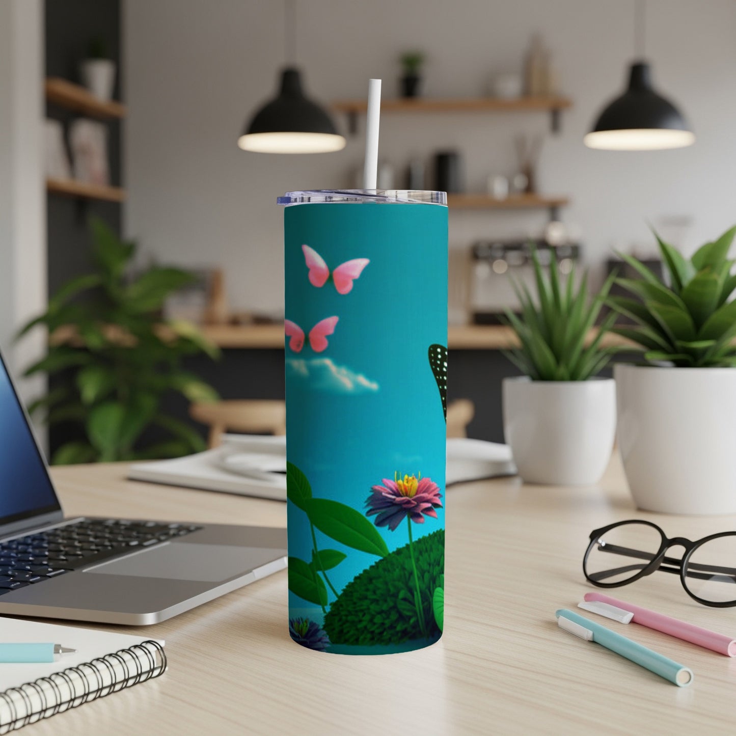 Teal tumbler with pink butterflies and a purple flower against a blue sky.