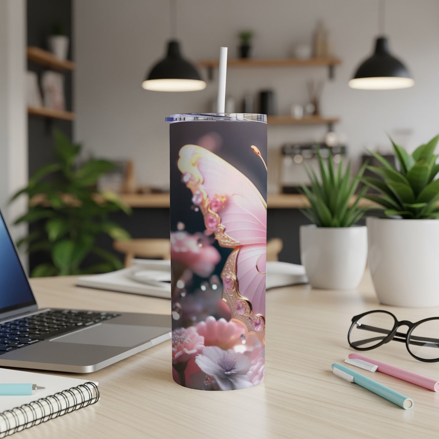 Pink butterfly and floral design on a tumbler with a straw.