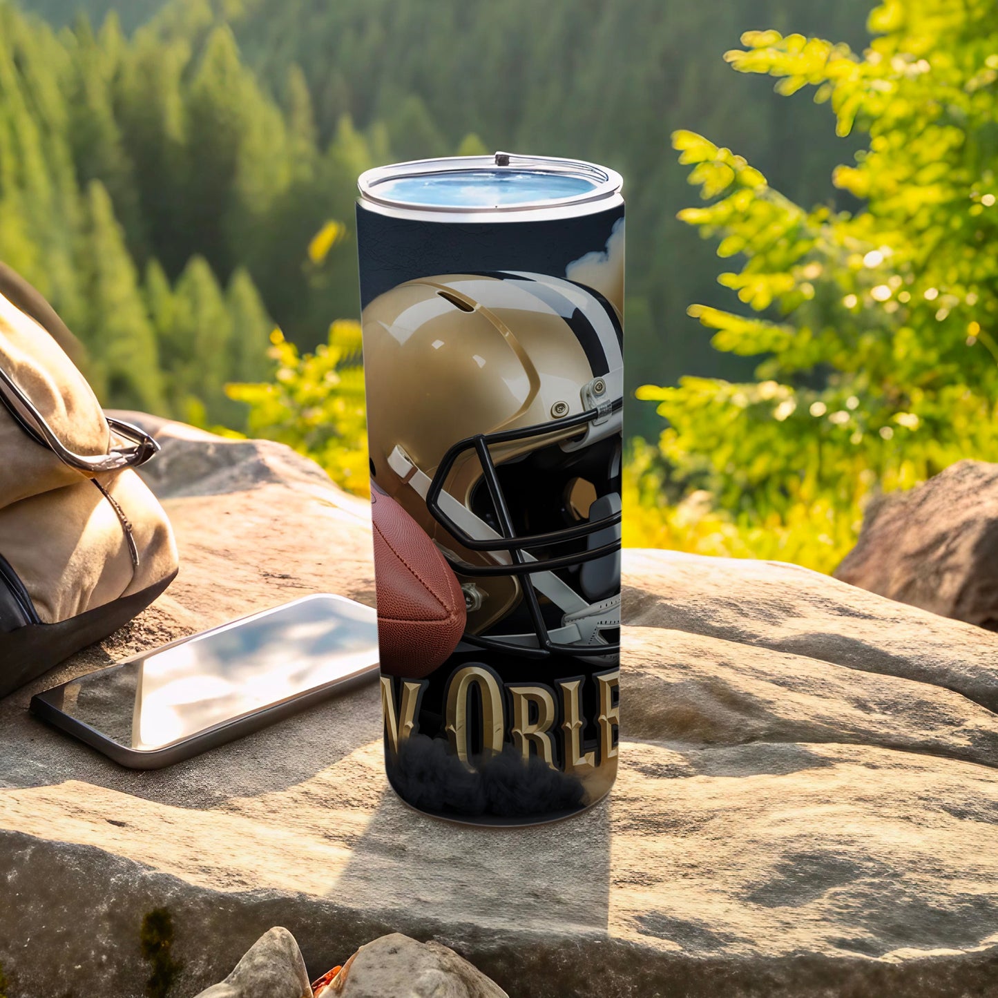 Gold New Orleans Saints helmet and football on a rock with a phone and backpack.