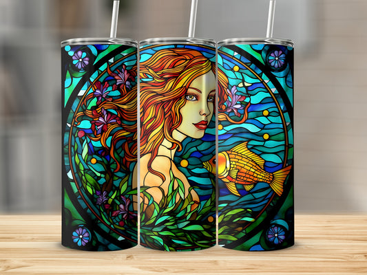 Stained glass mermaid with goldfish and floral elements on a tumbler.