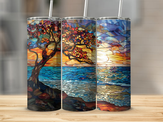 Three stained glass tumblers featuring a sunset over the ocean and a tree.