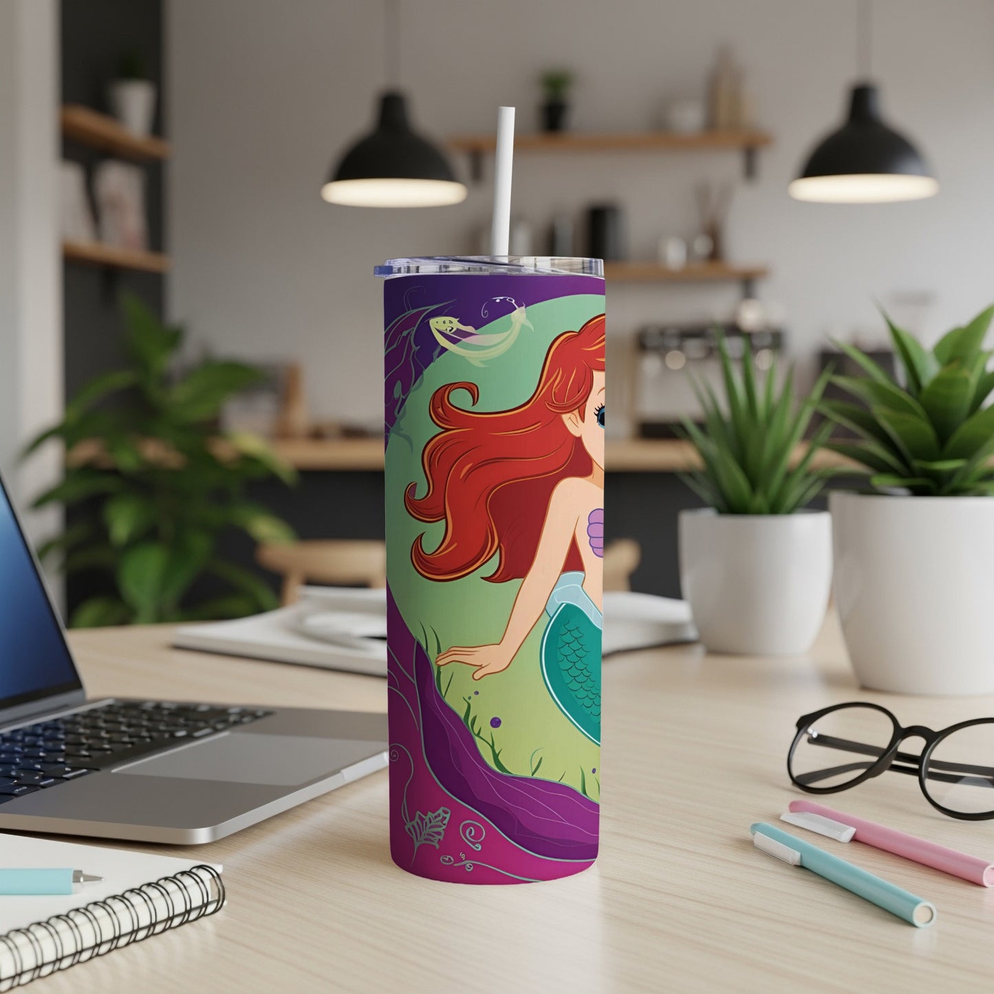 Ariel from The Little Mermaid on a purple tumbler with a straw.