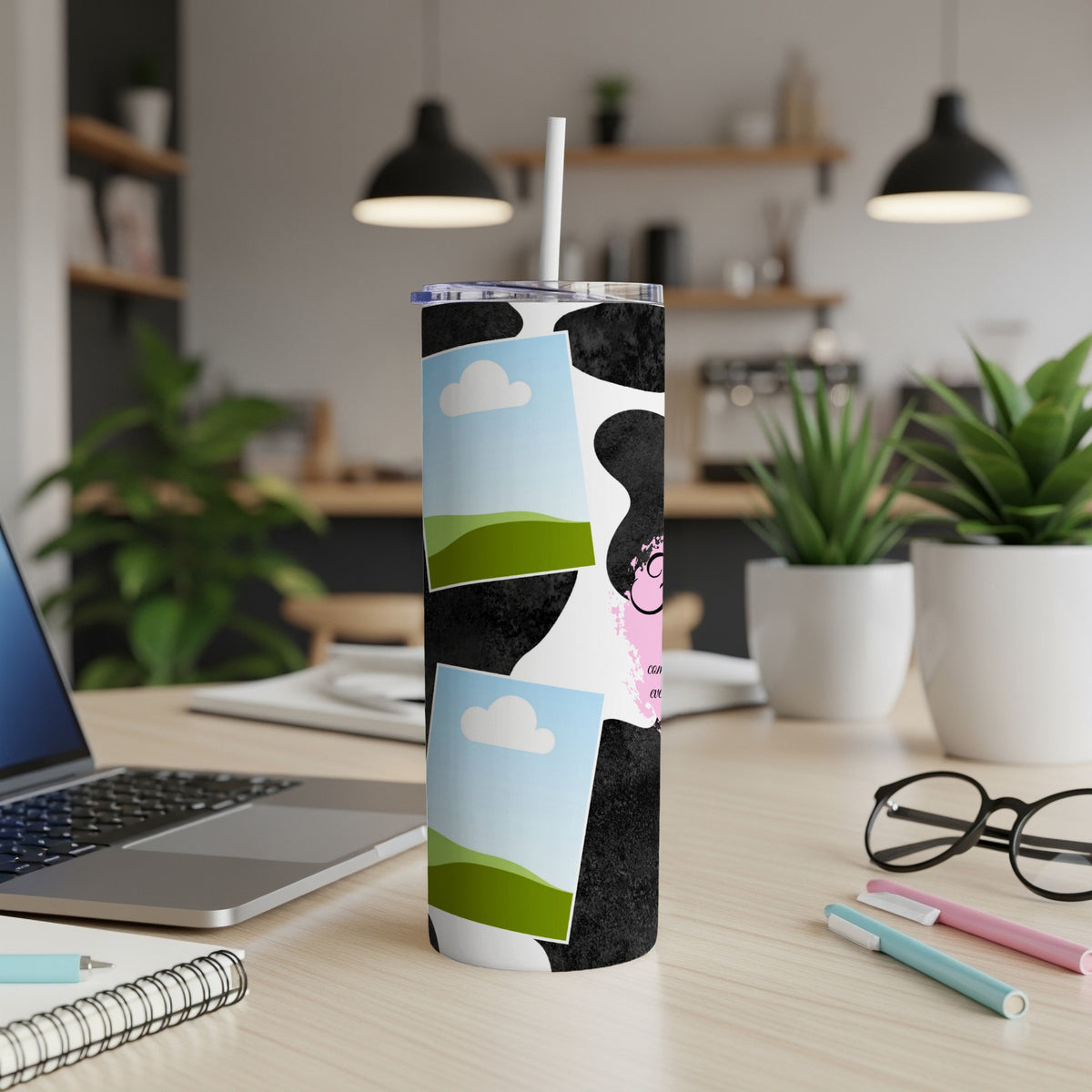 Black and white cow print tumbler with framed photos and pink accents.