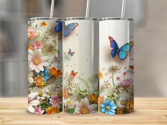 Three white tumblers with colorful floral and butterfly designs on a wooden surface.