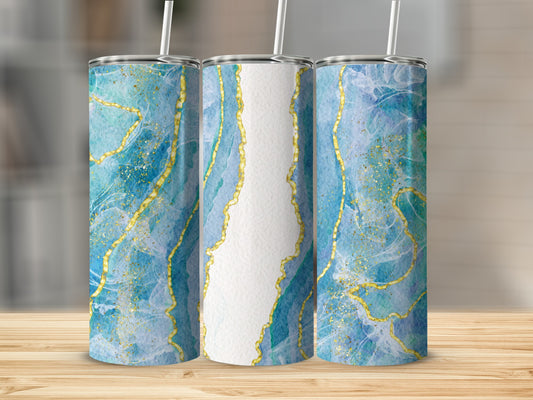 Three tumblers with blue and gold marbled design on a wooden surface.