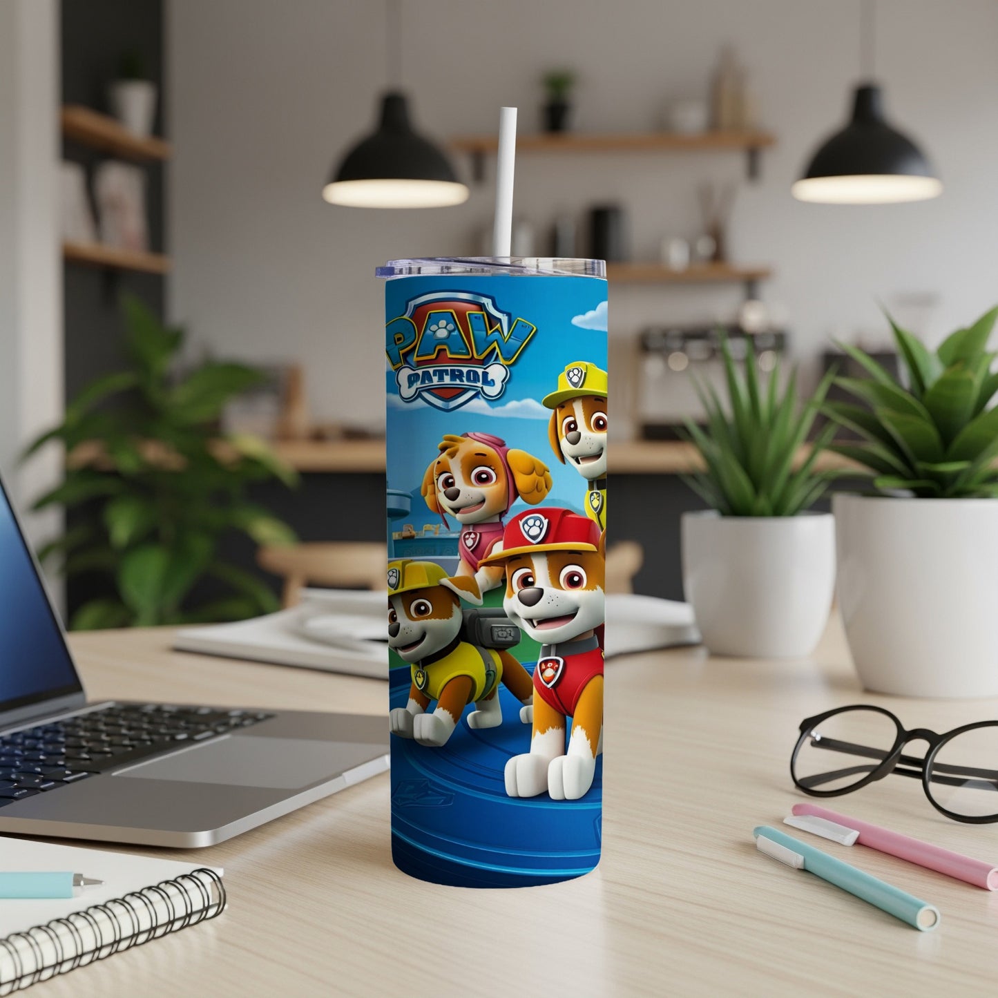 Paw Patrol characters Ryder, Chase, Marshall, and Rubble on a blue tumbler with straw.