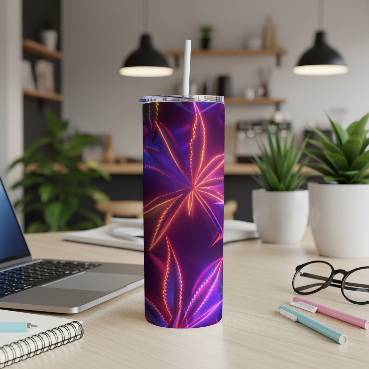 Purple tumbler with neon cannabis leaf design and straw.