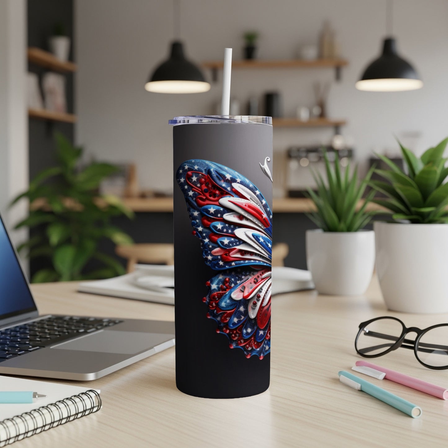 Black tumbler with American flag butterfly design and straw.