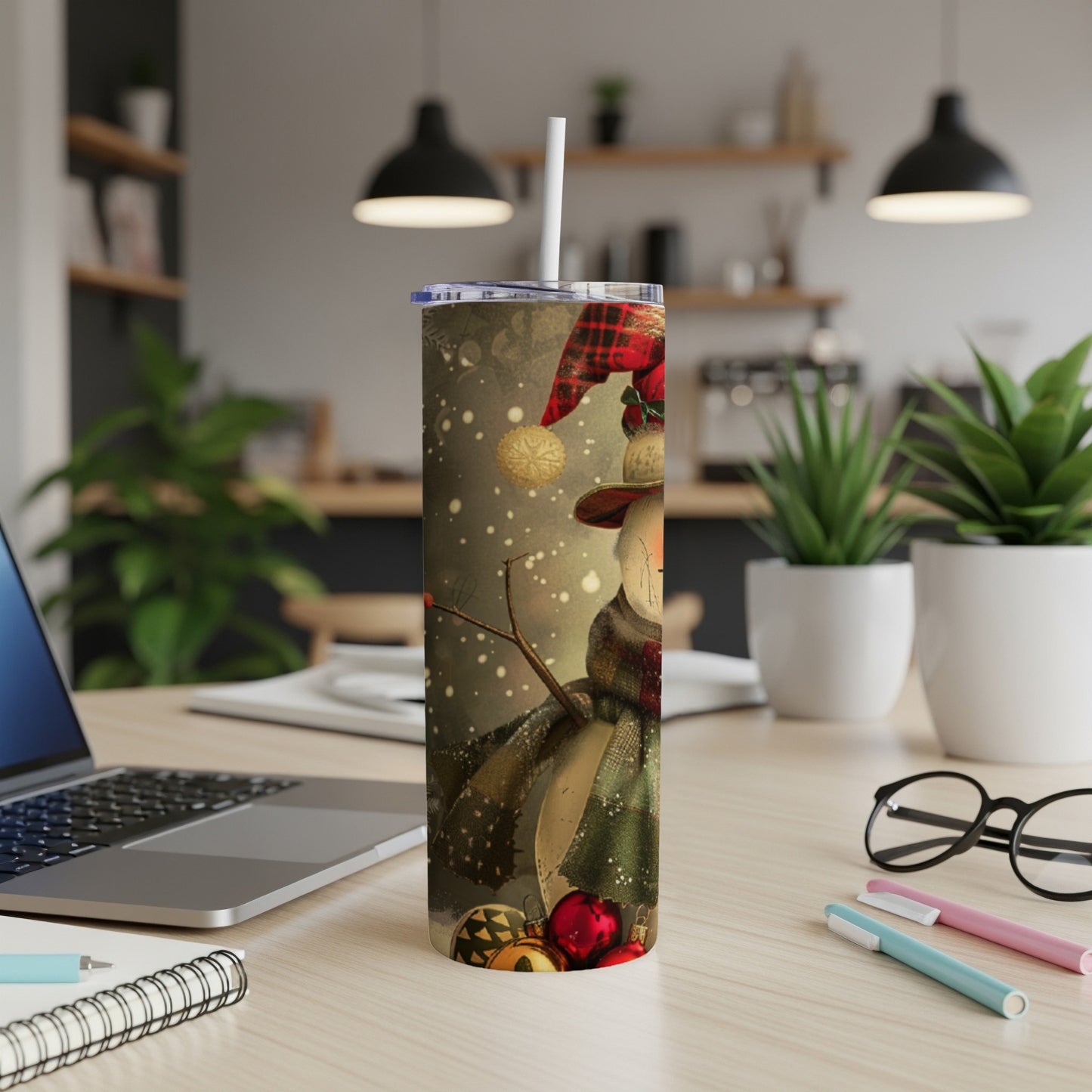 Tumbler with a snowman design featuring plaid scarf and holiday ornaments.