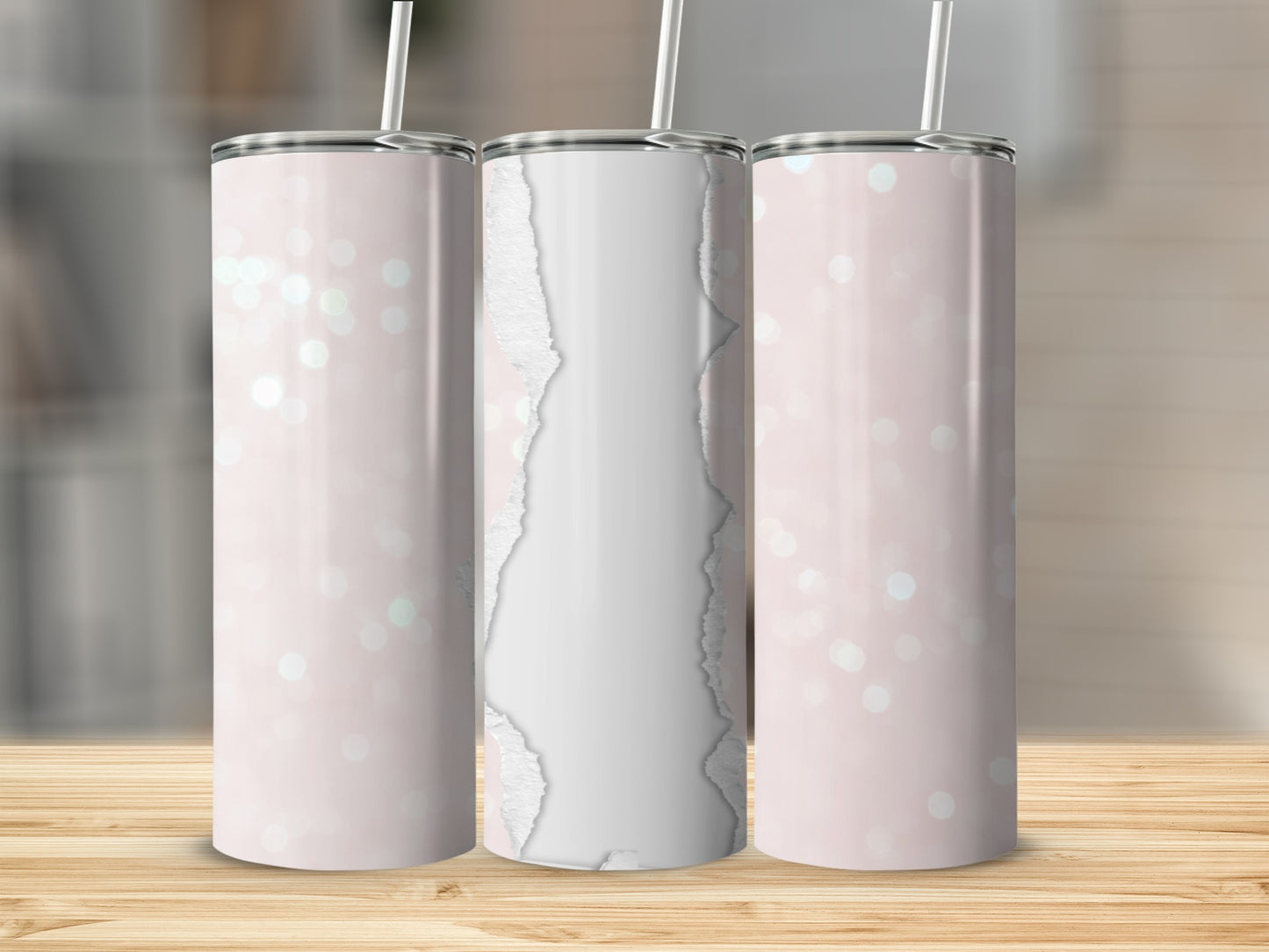 Pink tumbler with ripped paper design and bokeh background.