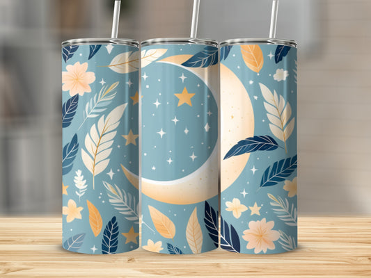 Blue tumbler with crescent moon, stars, and floral leaf pattern.