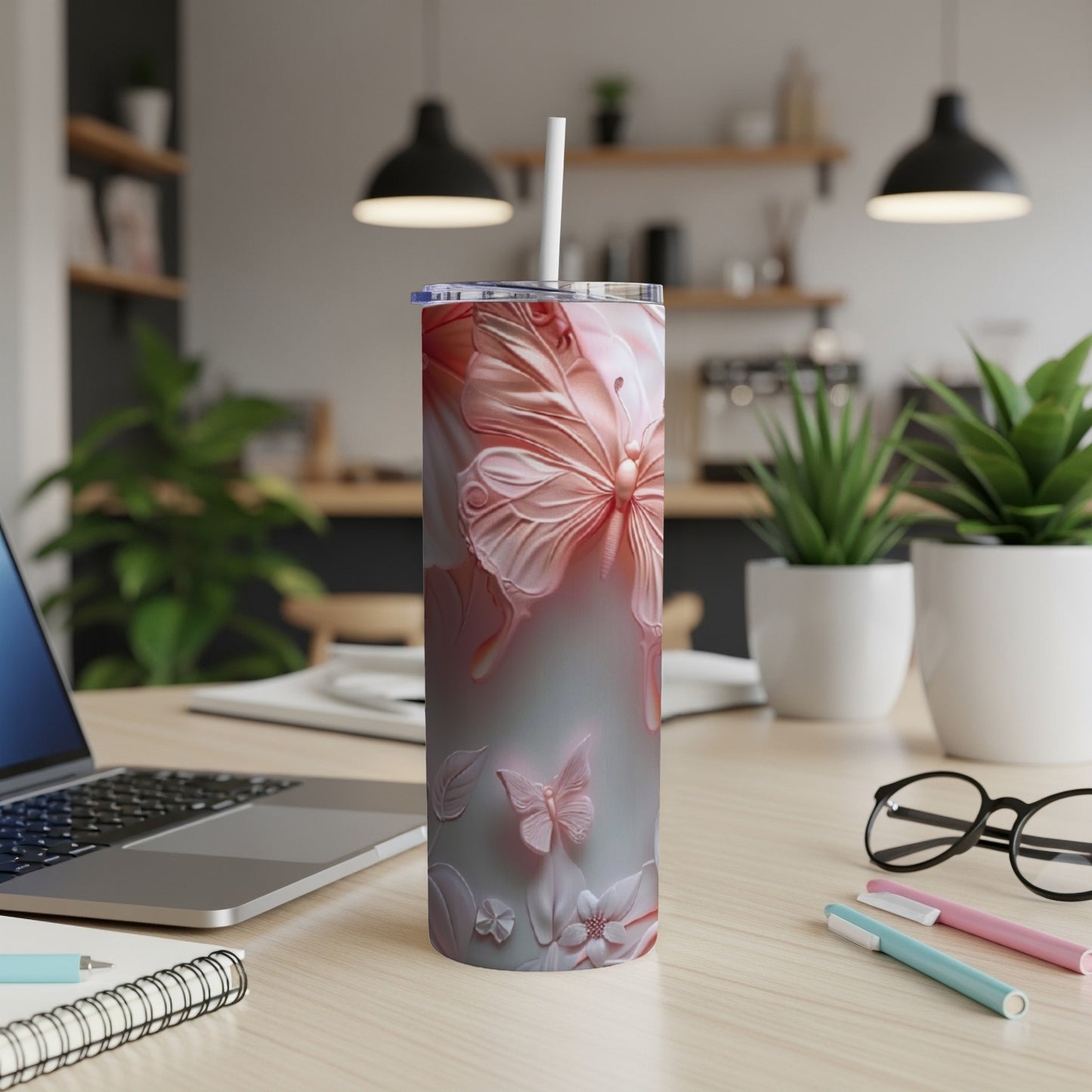 Pink butterfly and floral design on a skinny tumbler with straw.