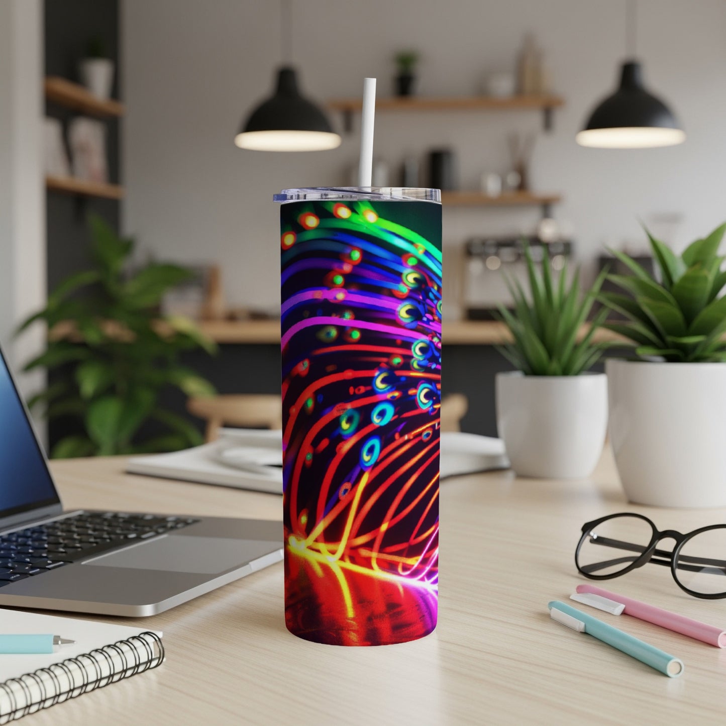 Brightly colored neon abstract lines on a tall stainless steel tumbler with straw.