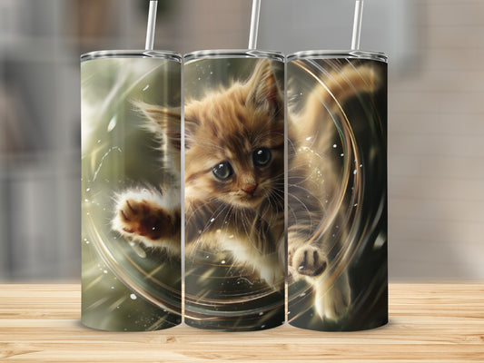 Orange kitten in swirling light on a tumbler.