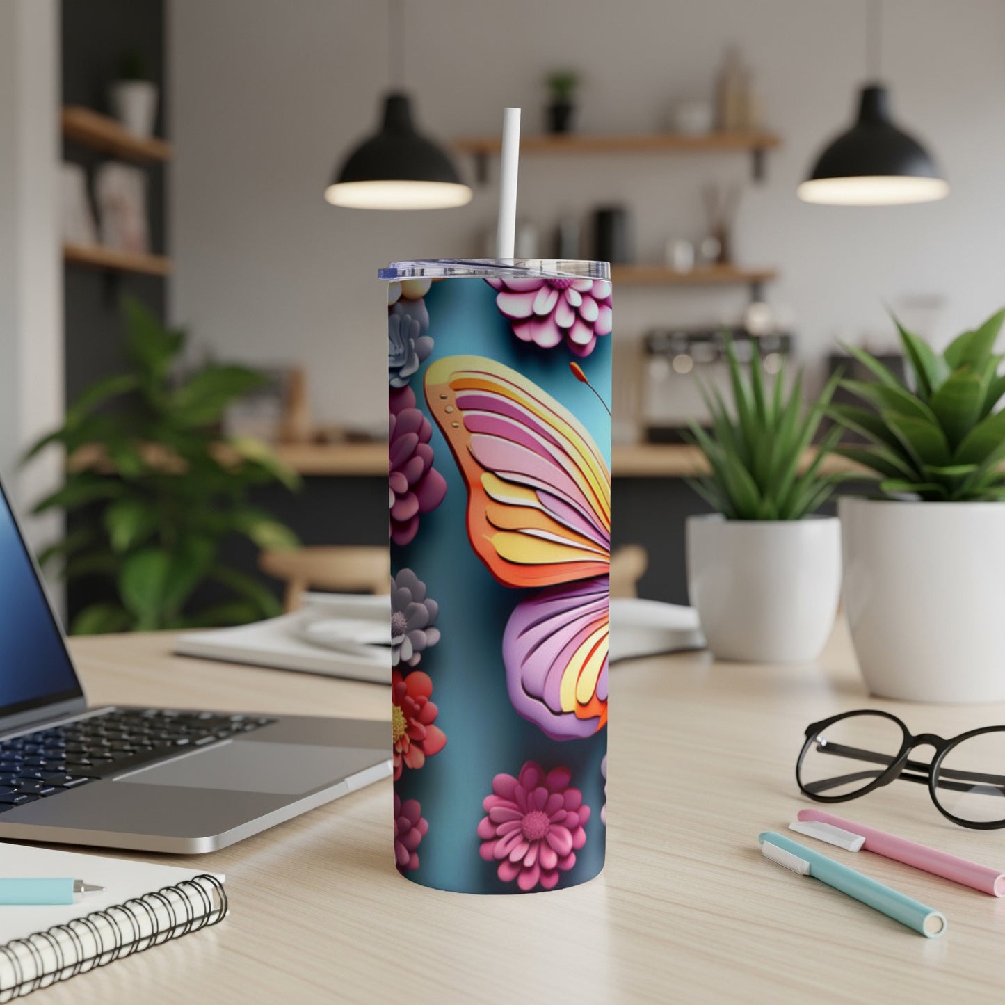 Tall tumbler with butterfly and floral design, straw in lid.