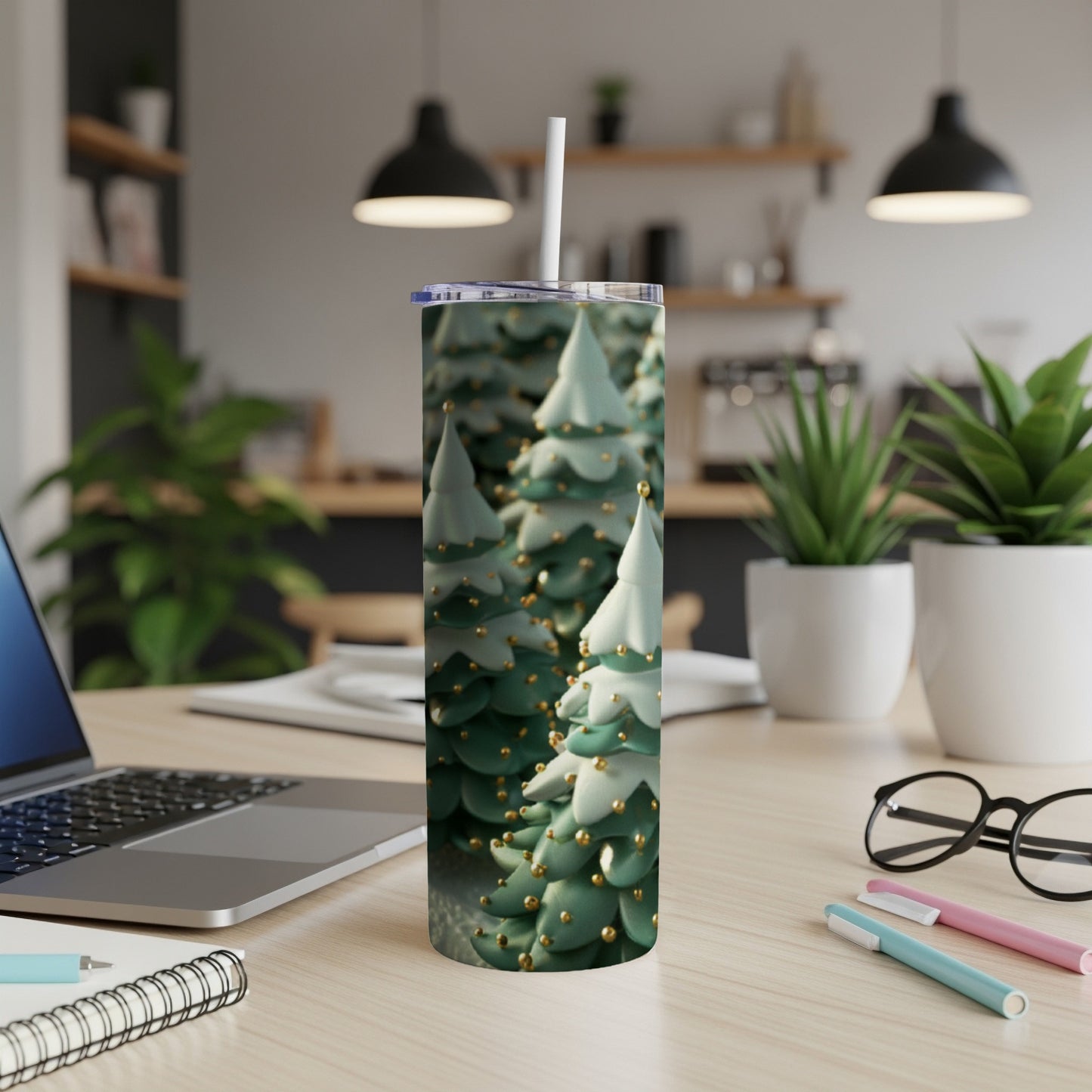 Green and white Christmas trees with gold ornaments on a tumbler.