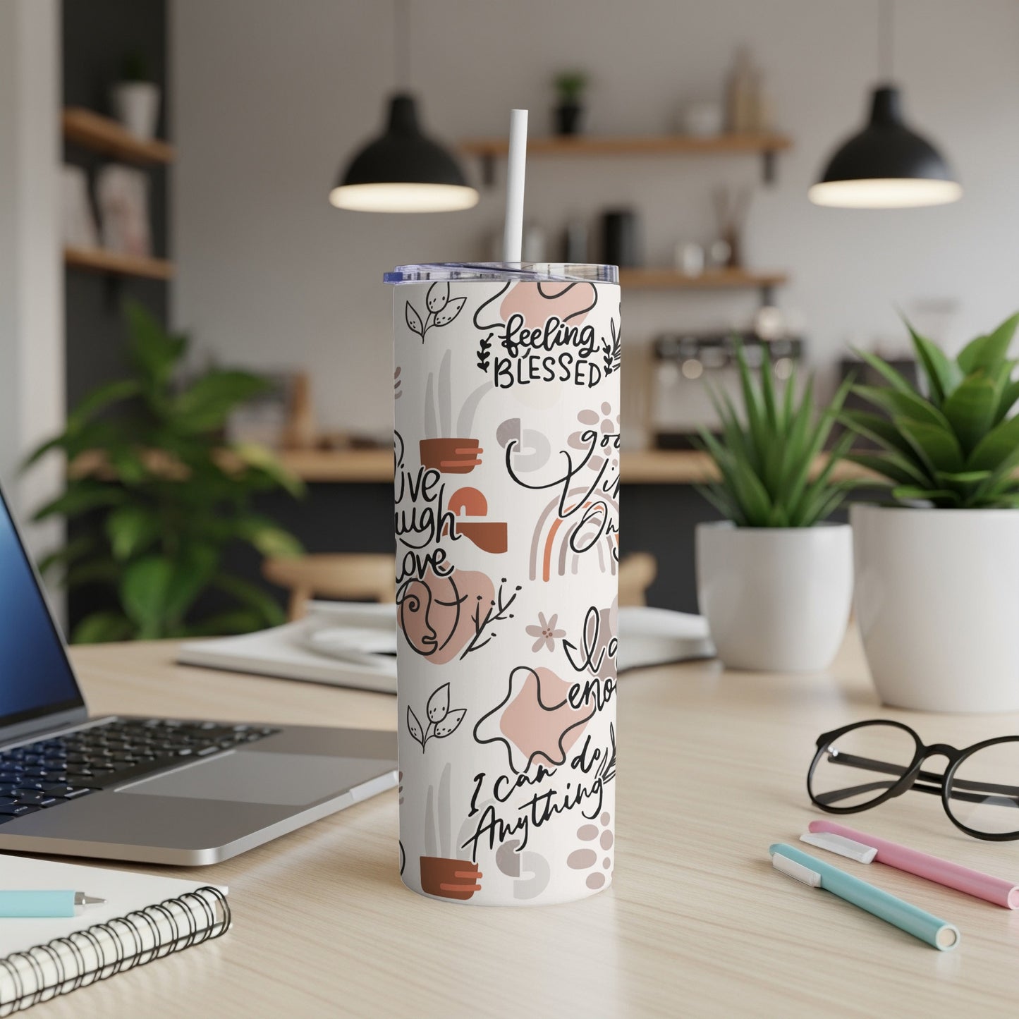 White tumbler with abstract designs and text "Feeling Blessed" and "I Can Do Anything".