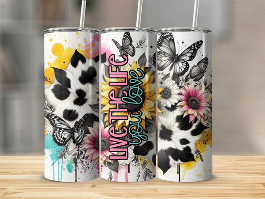 Tumbler with cow print, sunflowers, and butterflies, text "Live the life you love."