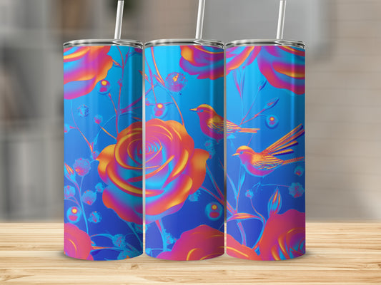 Blue tumbler with vibrant roses and birds, set on a wooden surface.