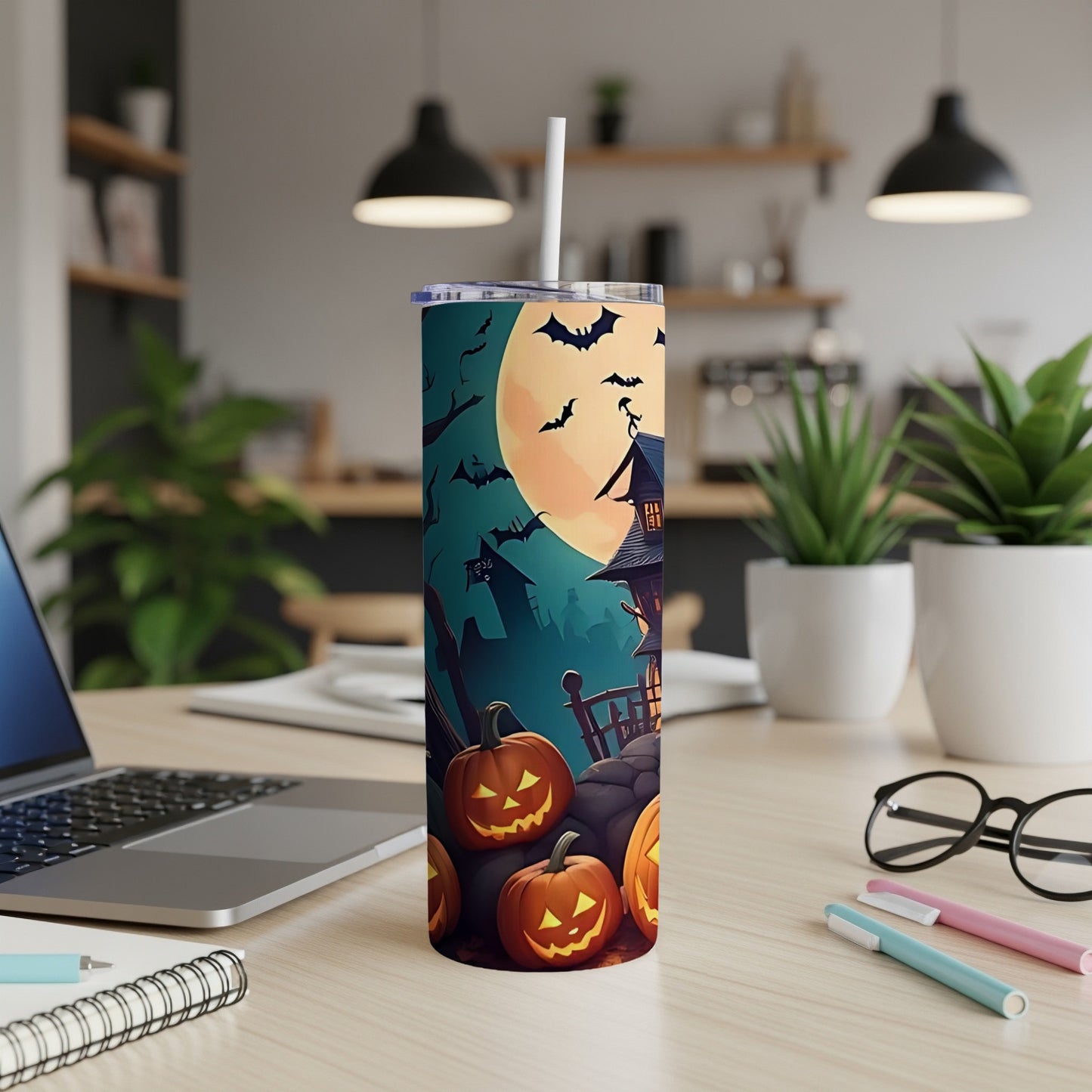 Tumbler with Halloween pumpkins, haunted house, and bats on a full moon background.