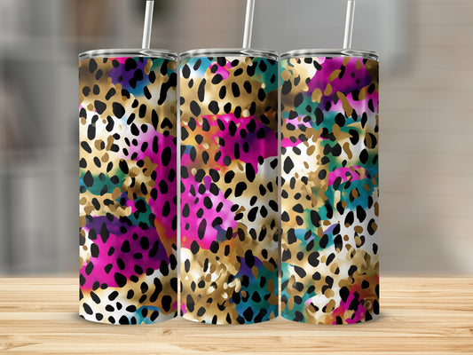 Three tumblers with colorful leopard print patterns stand on a wooden surface.