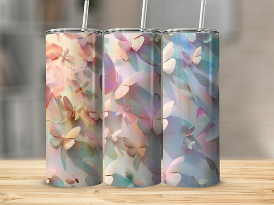 Three tumblers with pastel butterfly designs and straws.
