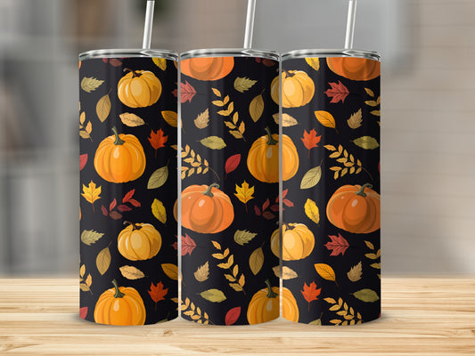 Three tumblers featuring a fall pumpkin and leaf pattern on a wooden surface.