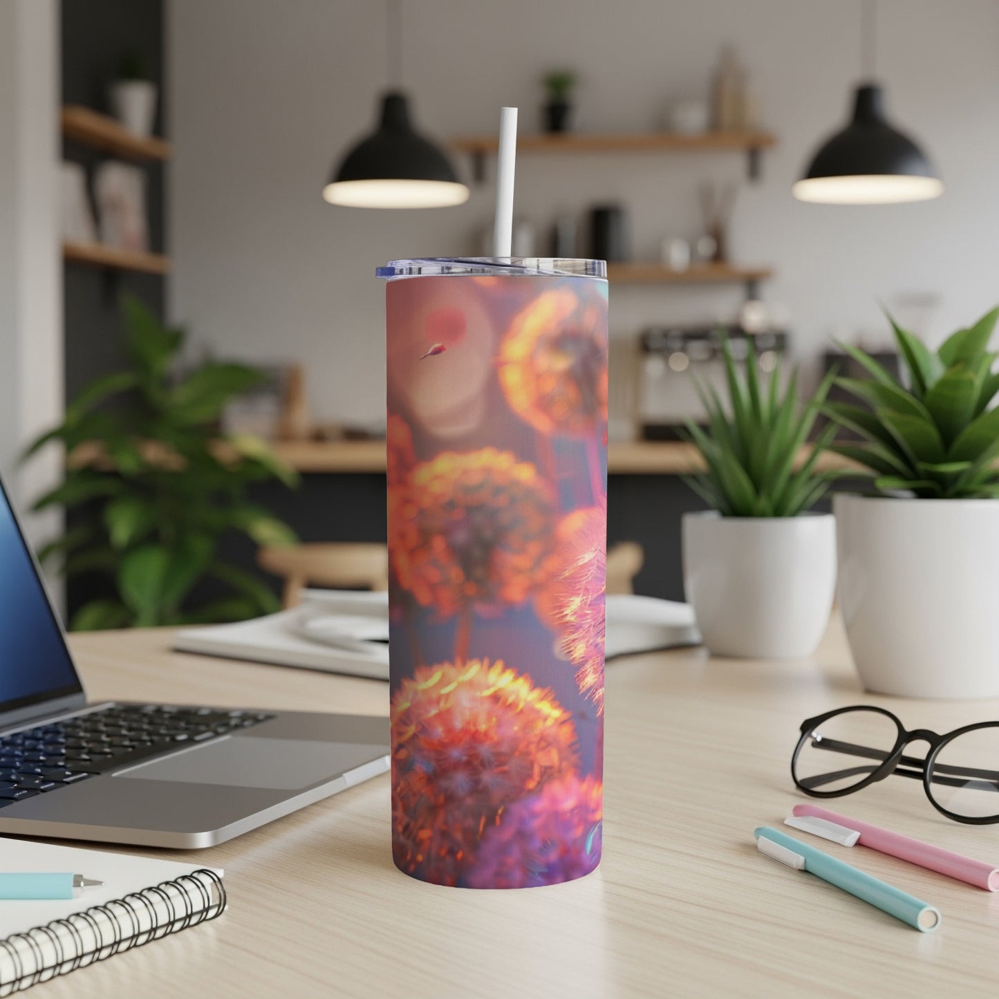 A colorful dandelion print on a stainless steel tumbler with a straw.
