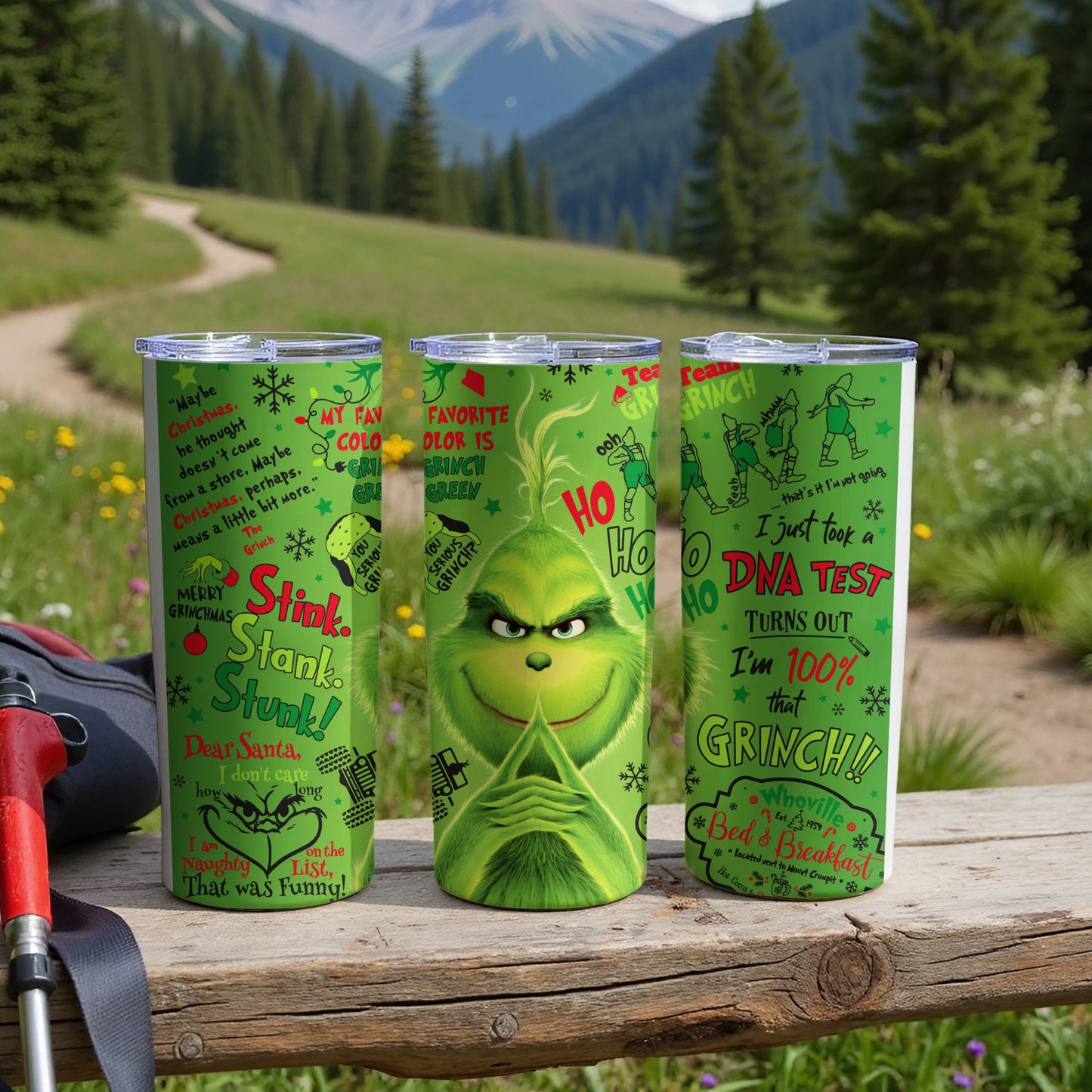 Three green tumblers featuring The Grinch and holiday quotes.