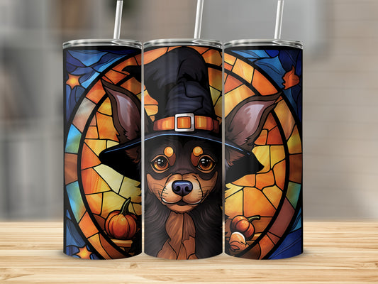 Chihuahua in a witch hat with pumpkins, stained glass background.