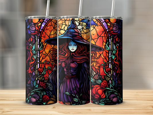 Stained glass witch with red hair and a blue hat on a tumbler.