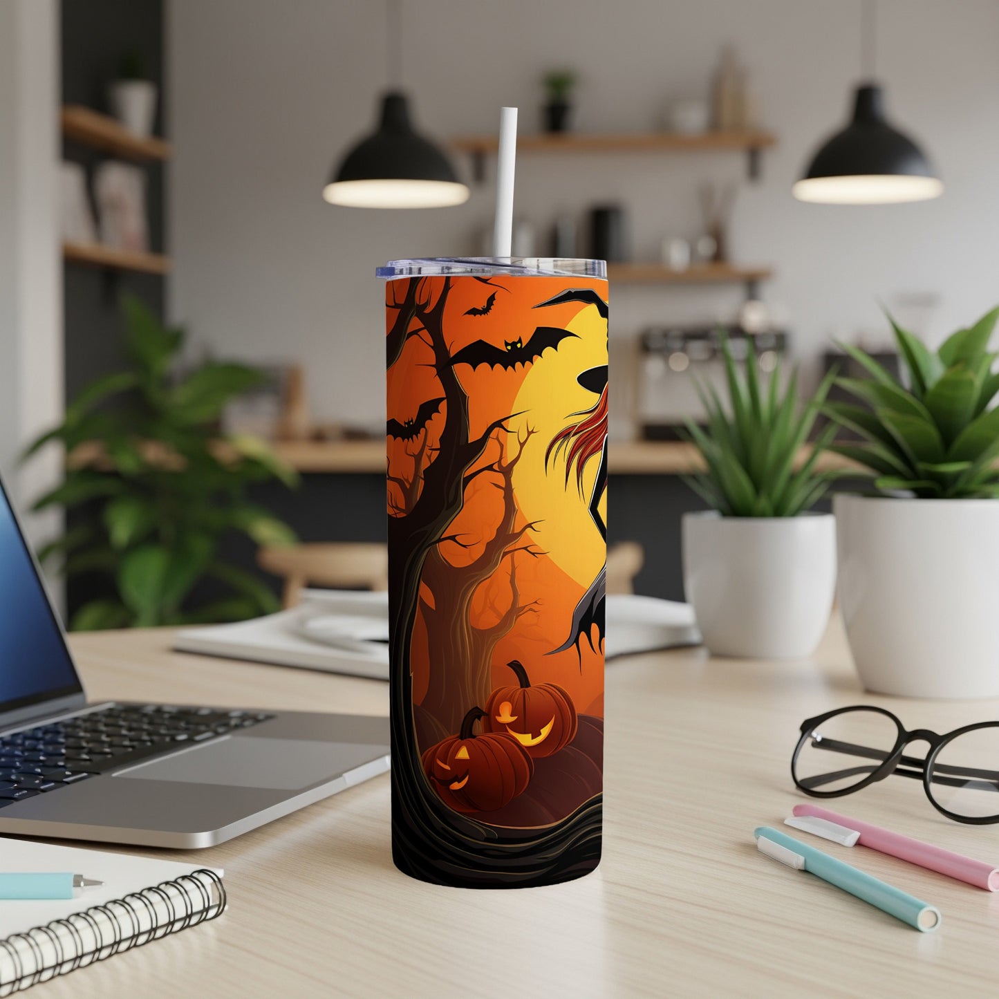Tall Halloween tumbler with witch, bats, pumpkins, and spooky trees on orange background.