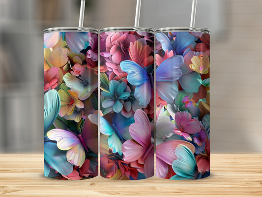 Three tumblers with a colorful butterfly and floral design on a wooden surface.