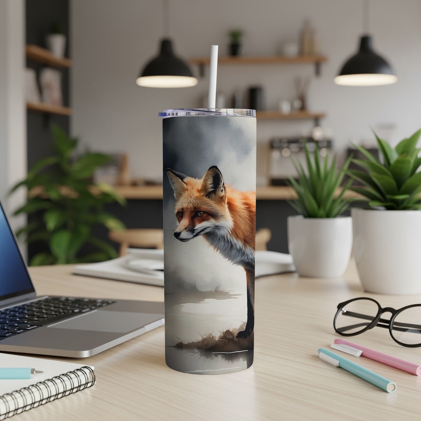 Realistic fox illustration on a white tumbler with a straw, on a desk.