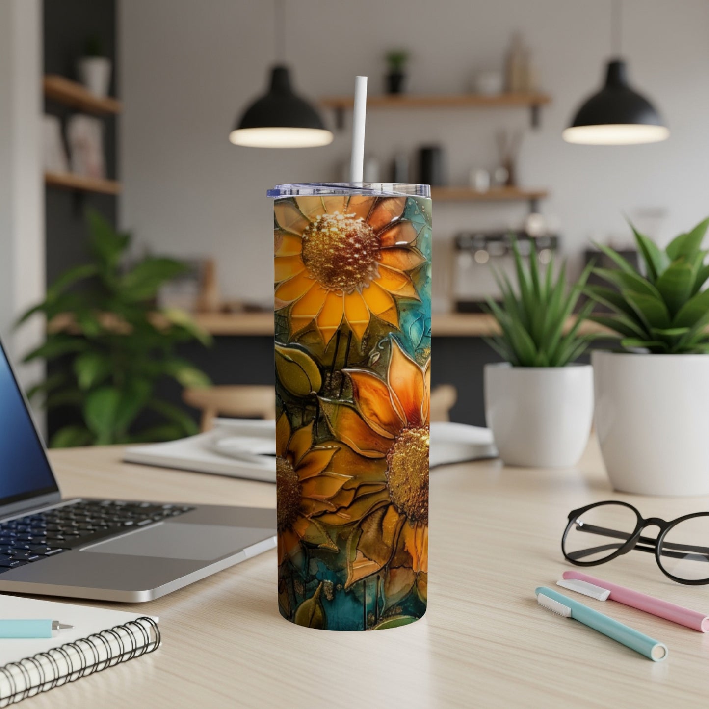 Tall tumbler with a stained-glass sunflower design, set on a desk.