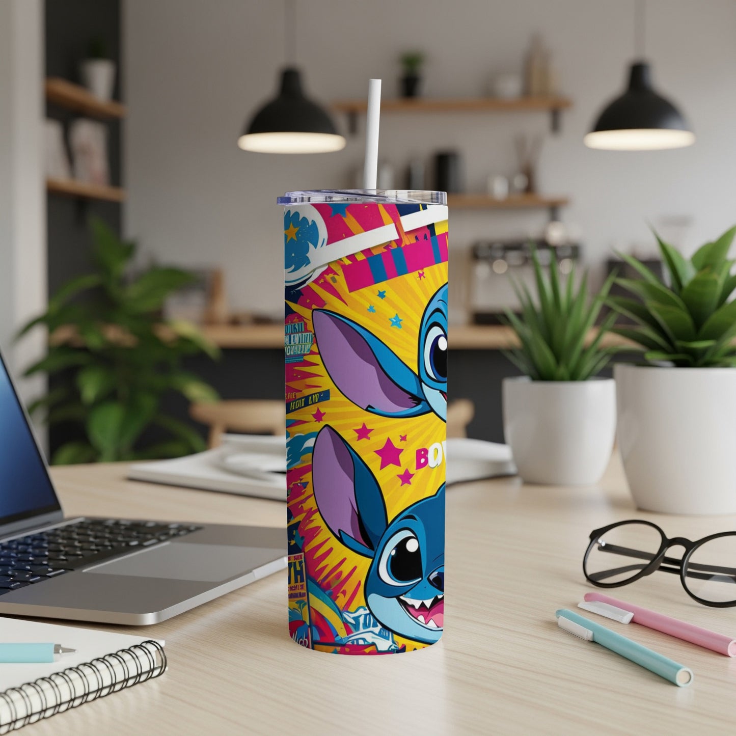 Blue alien character with pink ears on a colorful, patterned tumbler with a straw.