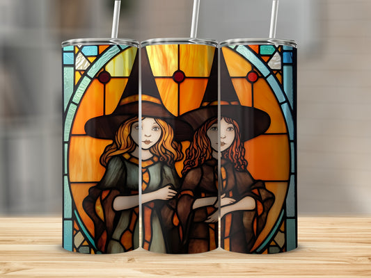 Three witches wearing pointed hats in stained glass window design.