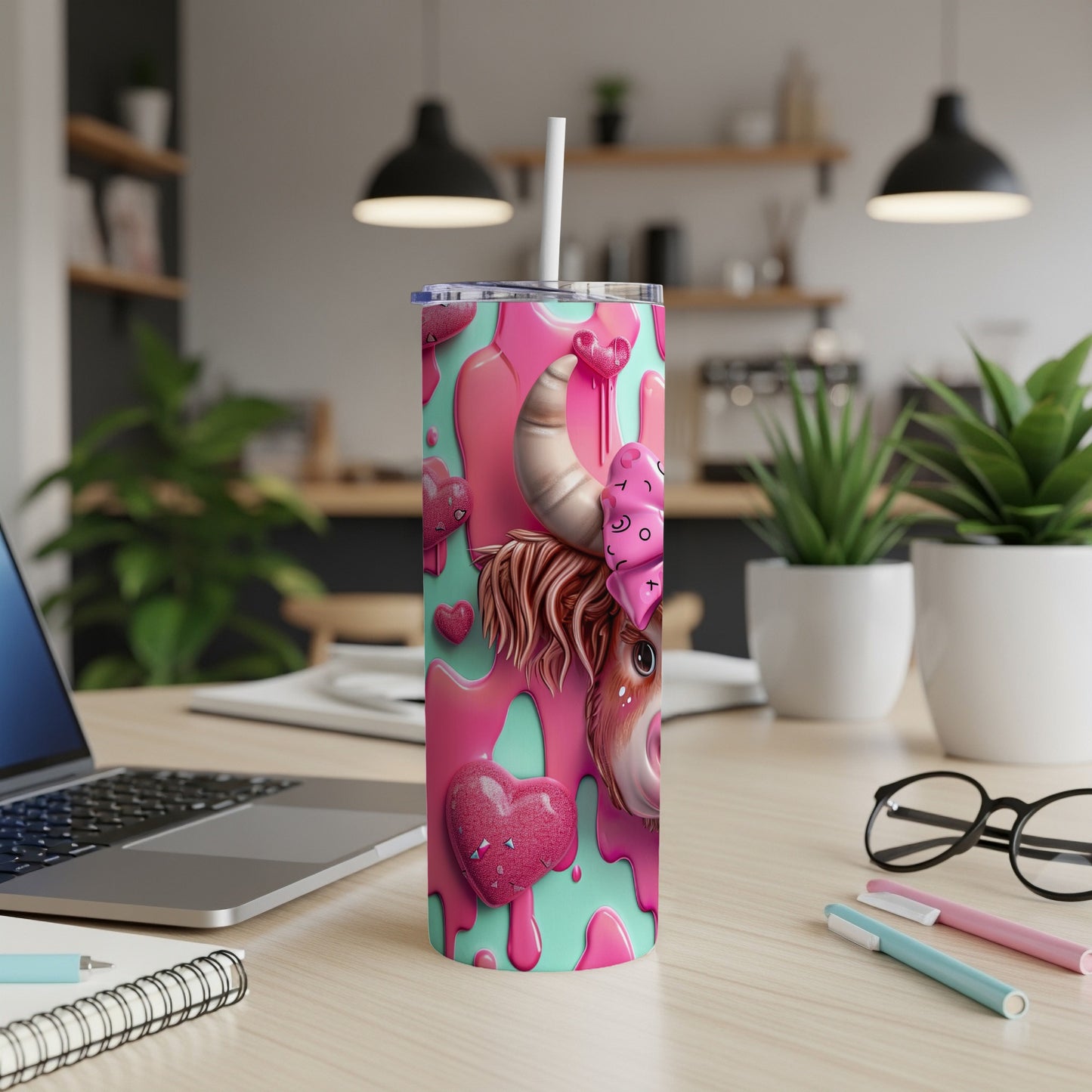 Pink and teal tumbler with cow print and heart details.