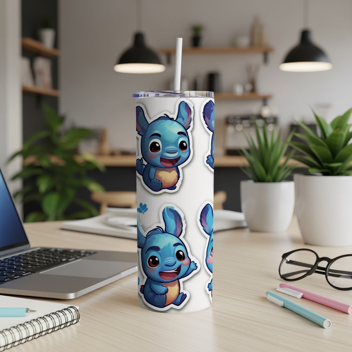 Blue cartoon alien character stickers on a white skinny tumbler.