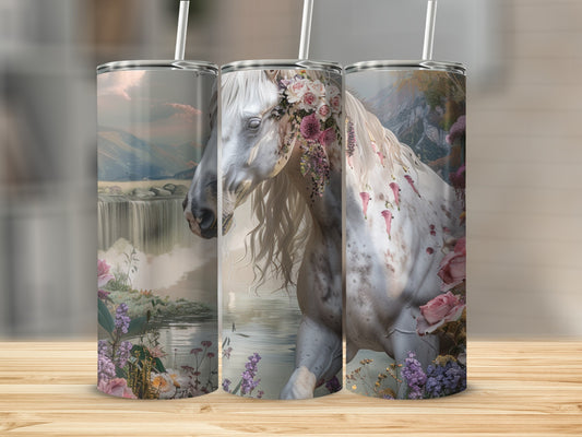 White horse with floral crown in waterfall landscape.