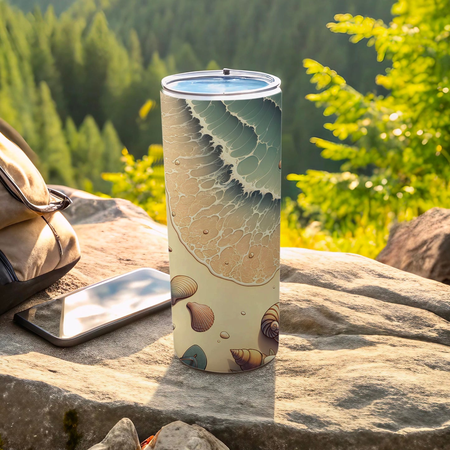 Tall tumbler with a beach wave and seashell design on a rock.