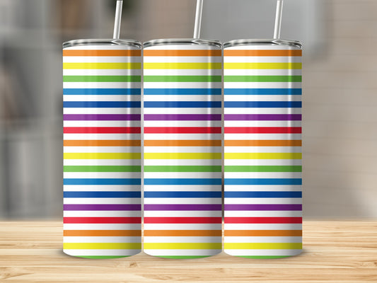 Three tall tumblers with rainbow stripe patterns stand side-by-side on a wooden surface.