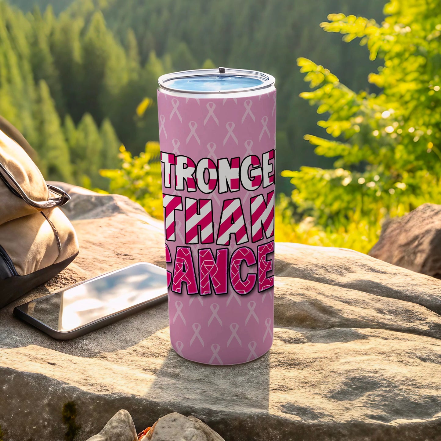 Pink tumbler with "Stronger Than Cancer" text and ribbon pattern.